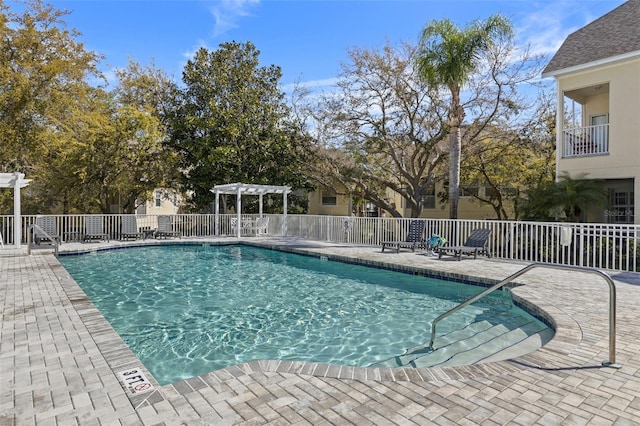 pool featuring a pergola, a patio, and fence