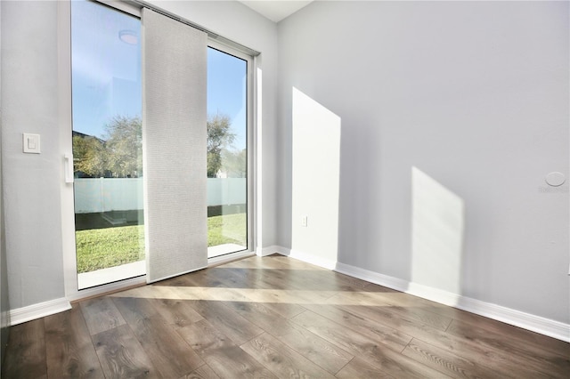 empty room with wood finished floors and baseboards