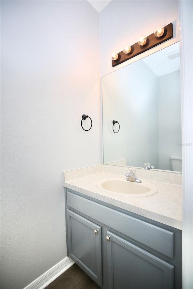 bathroom with visible vents, vanity, and baseboards