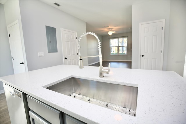 kitchen featuring light stone counters, visible vents, electric panel, a sink, and dishwasher