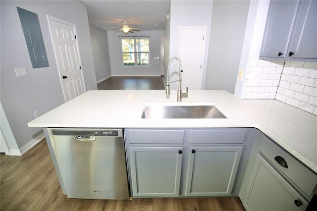 kitchen with a sink, a peninsula, light countertops, dishwasher, and ceiling fan