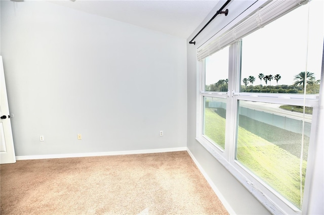 carpeted empty room with baseboards