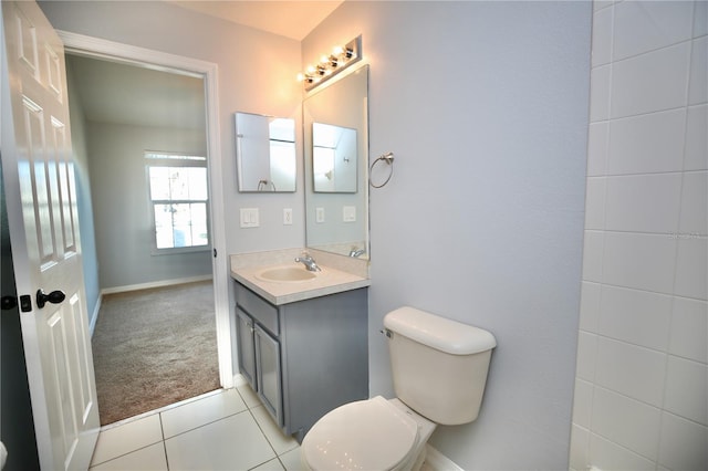 bathroom featuring tile patterned flooring, toilet, vanity, and baseboards