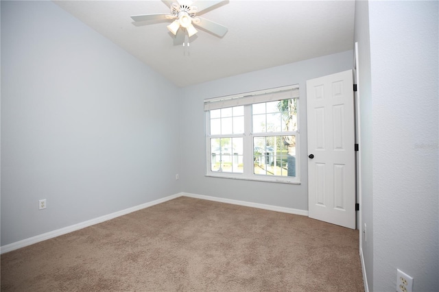 spare room with baseboards, a ceiling fan, carpet flooring, and vaulted ceiling