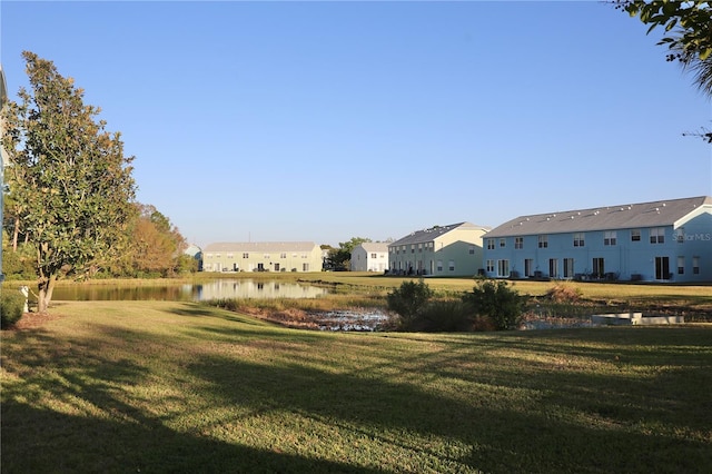 view of yard with a water view and a residential view