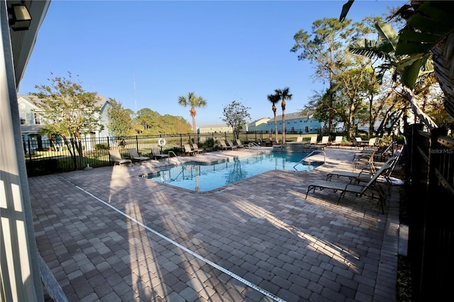 community pool featuring a patio area and fence