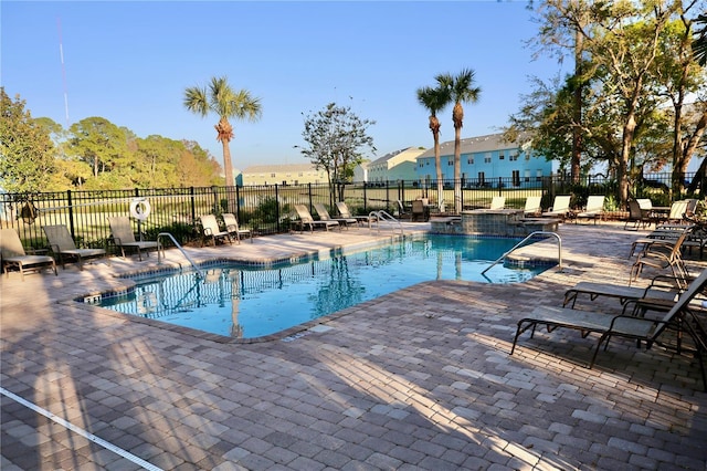 pool featuring a patio area and fence