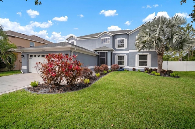 traditional home with driveway, a front yard, a garage, fence, and stucco siding
