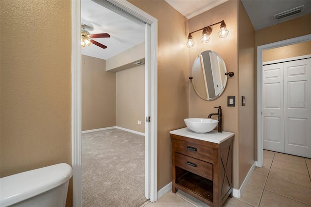 bathroom with ceiling fan, visible vents, vanity, baseboards, and toilet