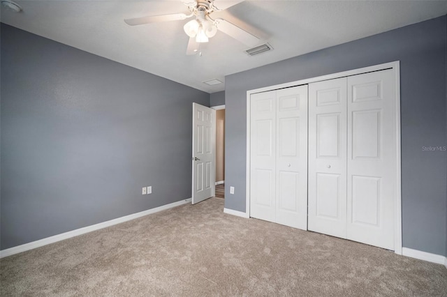 unfurnished bedroom with ceiling fan, carpet floors, baseboards, visible vents, and a closet
