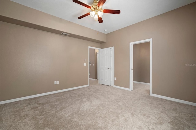 unfurnished bedroom with ceiling fan, light carpet, baseboards, and visible vents