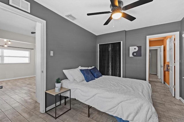 bedroom with visible vents, baseboards, and wood tiled floor