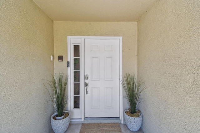 property entrance featuring stucco siding