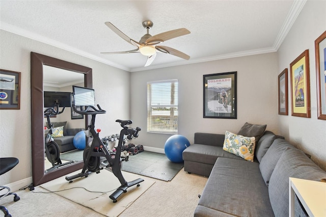 workout area featuring baseboards, a textured ceiling, ornamental molding, and a ceiling fan