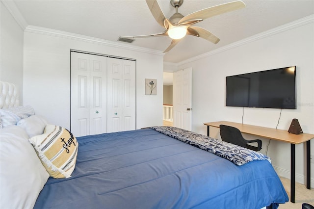 bedroom with visible vents, crown molding, carpet floors, a closet, and a ceiling fan