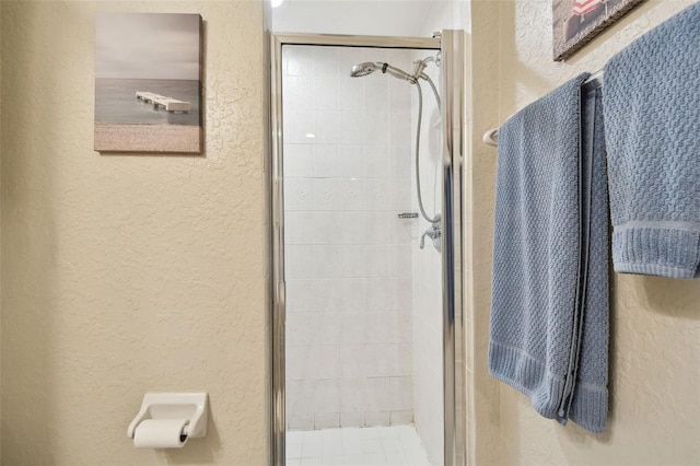 full bathroom with a stall shower and a textured wall