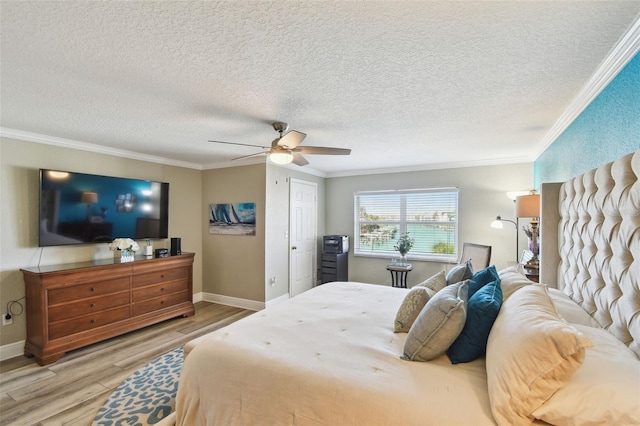 bedroom with light wood finished floors, baseboards, a ceiling fan, and ornamental molding