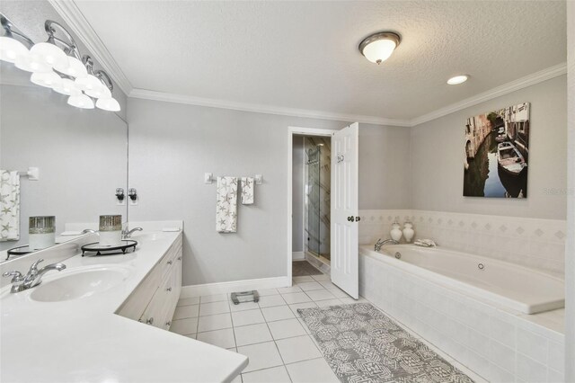 full bathroom with ornamental molding, a sink, a textured ceiling, tile patterned floors, and a bath