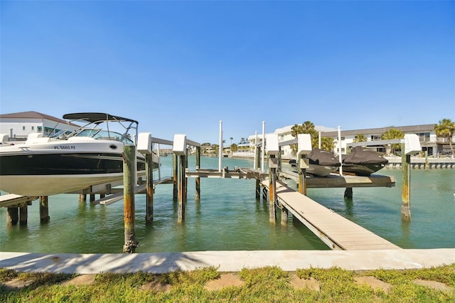 view of dock with boat lift and a water view