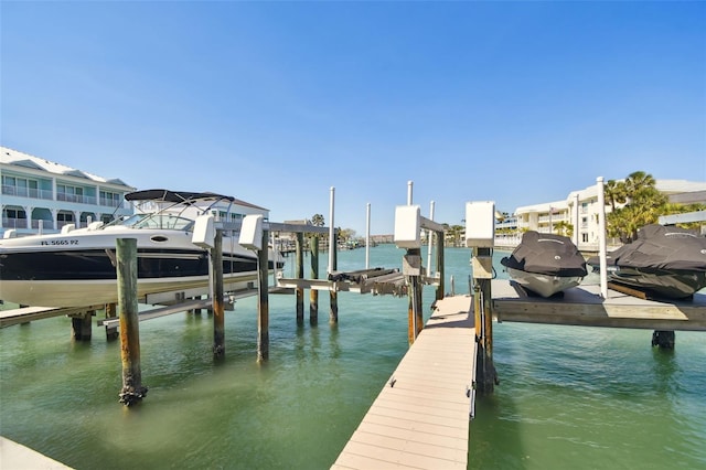 dock area with a water view and boat lift