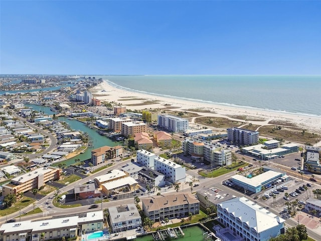 aerial view featuring a city view, a view of the beach, and a water view