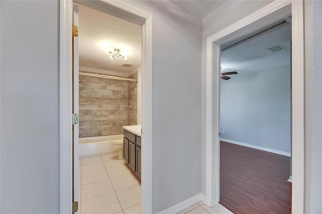 bathroom featuring tile patterned floors, visible vents, baseboards, and vanity