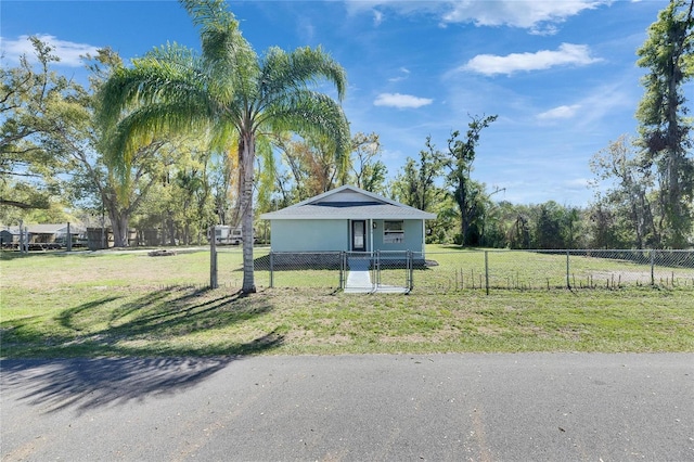 view of front facade with a fenced front yard and a front lawn