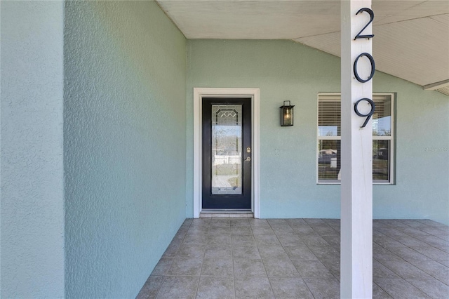 property entrance with stucco siding