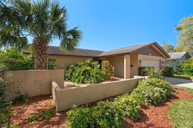 view of front of house featuring stucco siding, driveway, and an attached garage