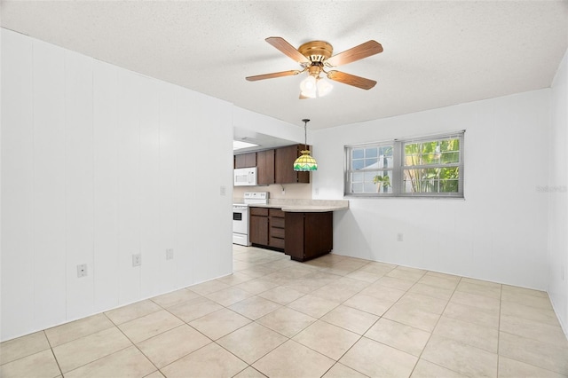 kitchen featuring white appliances, ceiling fan, hanging light fixtures, light countertops, and dark brown cabinets