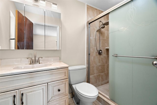 bathroom with vanity, toilet, and a shower stall