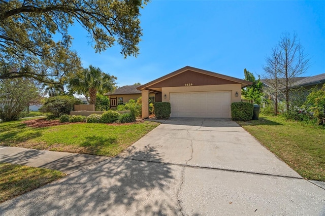 view of front of property featuring stucco siding, a front yard, concrete driveway, and an attached garage