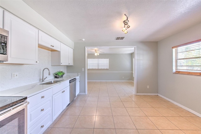 kitchen featuring visible vents, ceiling fan, light countertops, appliances with stainless steel finishes, and a sink