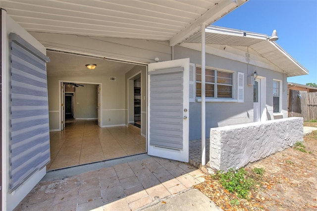 entrance to property with visible vents and a patio area