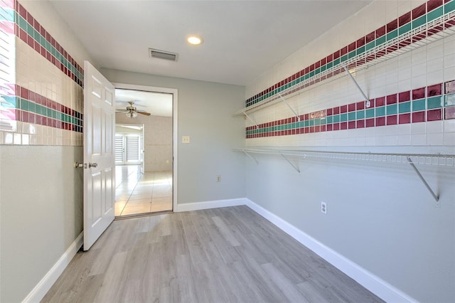 unfurnished bedroom featuring visible vents, baseboards, and wood finished floors