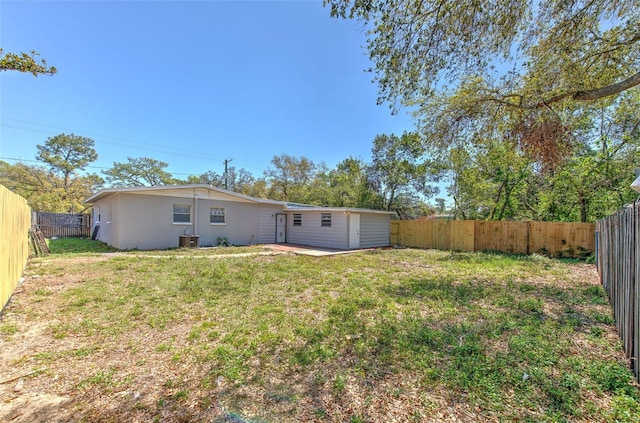 view of yard featuring central AC unit and a fenced backyard