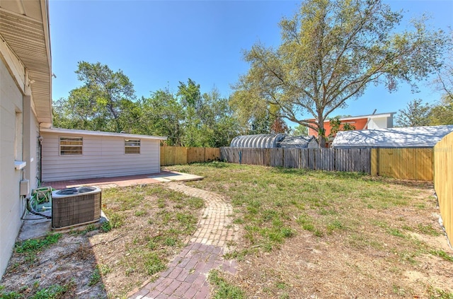 view of yard featuring central air condition unit and a fenced backyard