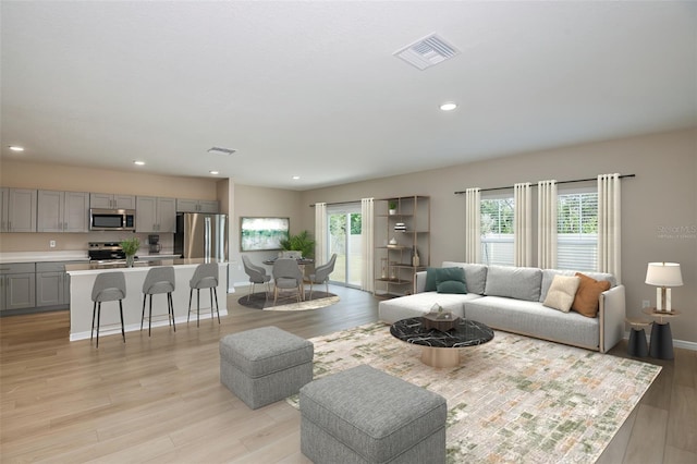 living room featuring recessed lighting, visible vents, light wood finished floors, and baseboards