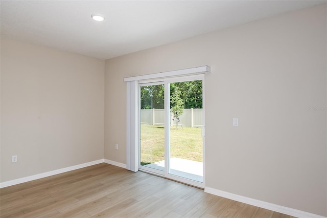 unfurnished room featuring light wood finished floors and baseboards