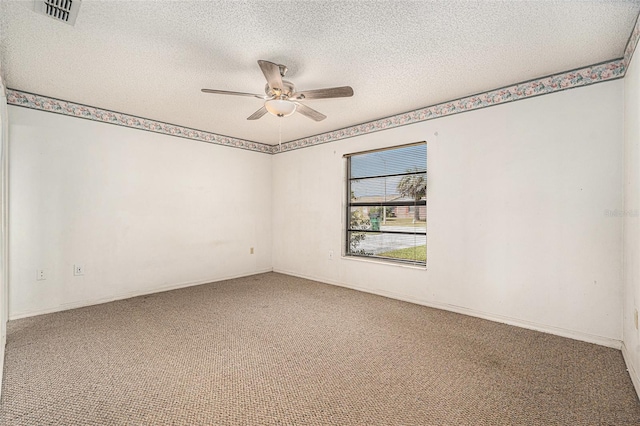 empty room with a ceiling fan, baseboards, visible vents, carpet floors, and a textured ceiling