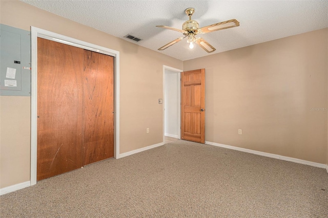 unfurnished bedroom featuring baseboards, visible vents, a closet, a textured ceiling, and carpet flooring