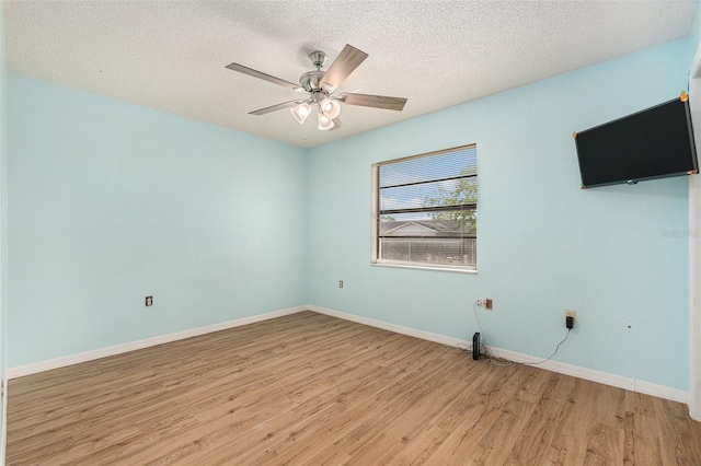 unfurnished room with baseboards, light wood-style floors, and a textured ceiling