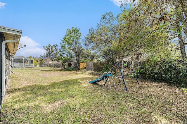 view of yard featuring a playground and fence