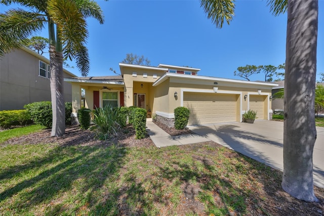 prairie-style home with a front yard, driveway, ceiling fan, stucco siding, and a garage