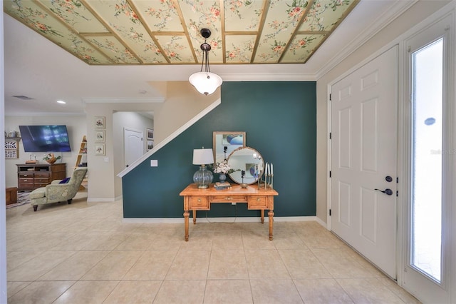 foyer entrance featuring baseboards, ornamental molding, and tile patterned flooring