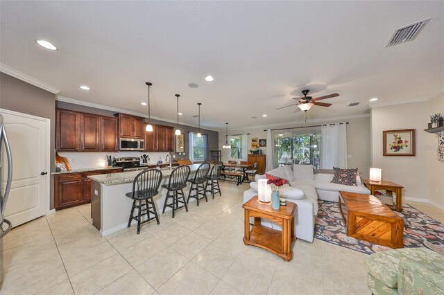 living room featuring visible vents, crown molding, light tile patterned floors, recessed lighting, and a ceiling fan