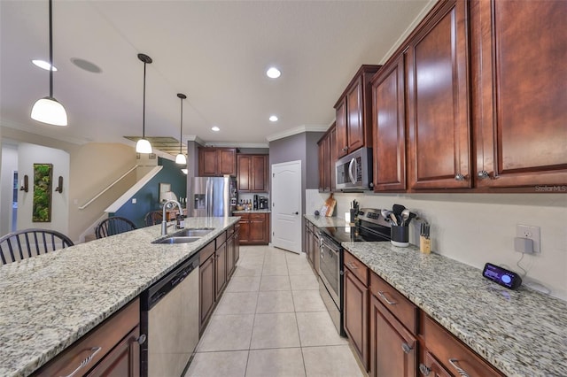 kitchen with a sink, light stone counters, stainless steel appliances, crown molding, and light tile patterned floors