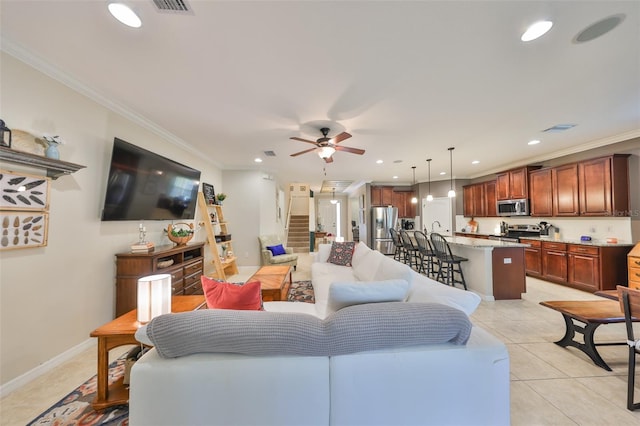 living area featuring baseboards, ceiling fan, ornamental molding, light tile patterned floors, and recessed lighting