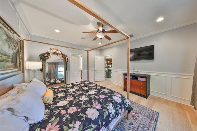 bedroom with visible vents, recessed lighting, light wood-style floors, wainscoting, and crown molding