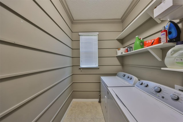 laundry area with ornamental molding, laundry area, tile patterned floors, a textured ceiling, and separate washer and dryer